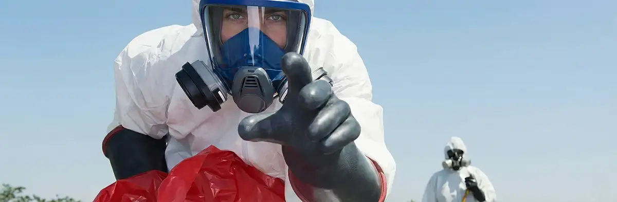 sewage clean up technician wearing protective gear handling biohazard materials in Grand Rapids, MI