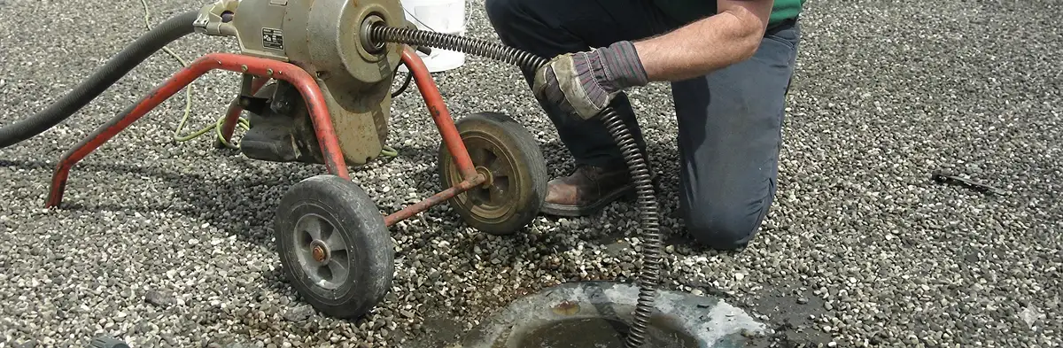 sewer rodding technician actively removing blockages from a sewer line in Grand Rapids, MI